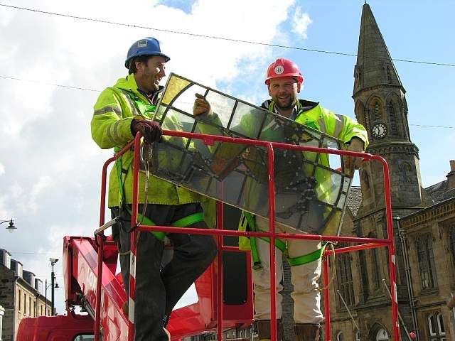 Douglas Spiers of Fife Council with colleague retrieving a window panel